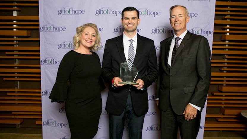 Travis Matics with award from Gift of Hope