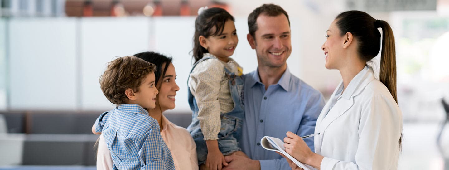 Doctor talking to a family at the hospital.