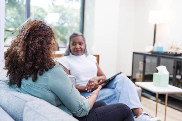 Therapy session between an adult and counselor in an open room