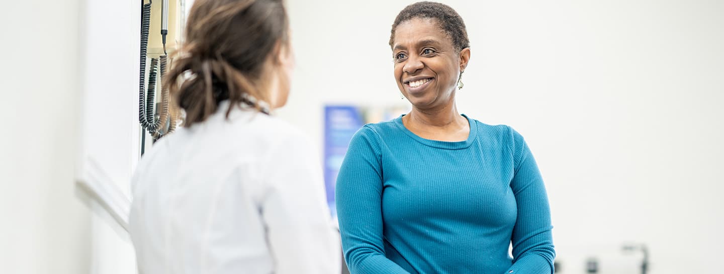 Image of woman talking to her primary care physician