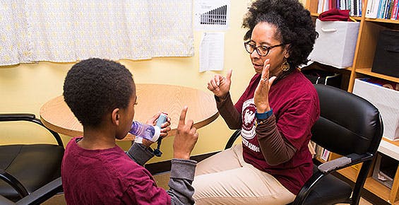 Urban Health Initiative nurse conducts asthma assessment with a student during a school visit