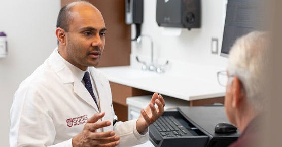 Nishant Agrawal, MD, and patient in clinic