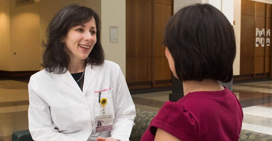 Stacy Lindau, MD, talking with a patient