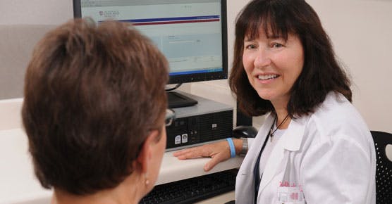 Wendy Stock, MD, talks with a patient in clinic