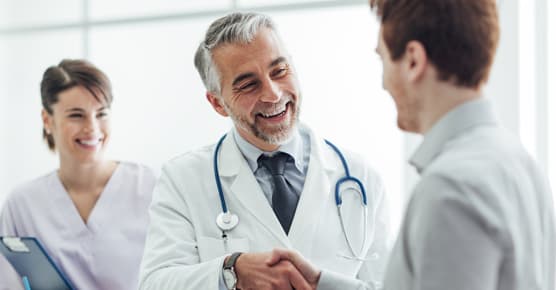 Female nurse and male doctor with male patient
