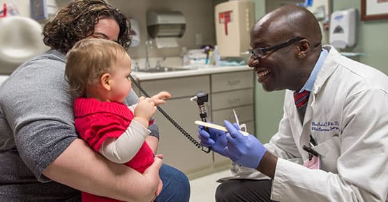 Dr. Russel Reid examining patient