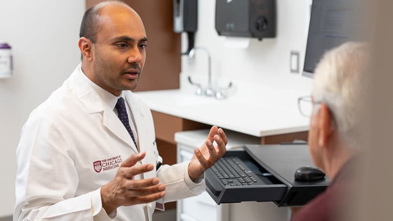 Nishant Agrawal, MD, meeting with a patient in clinic