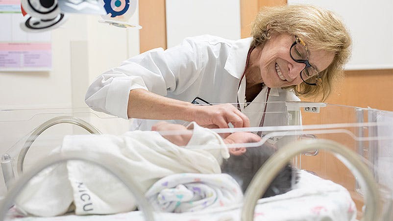 Pediatric surgeon Jessica Kandel, MD, checks on a NICU patient