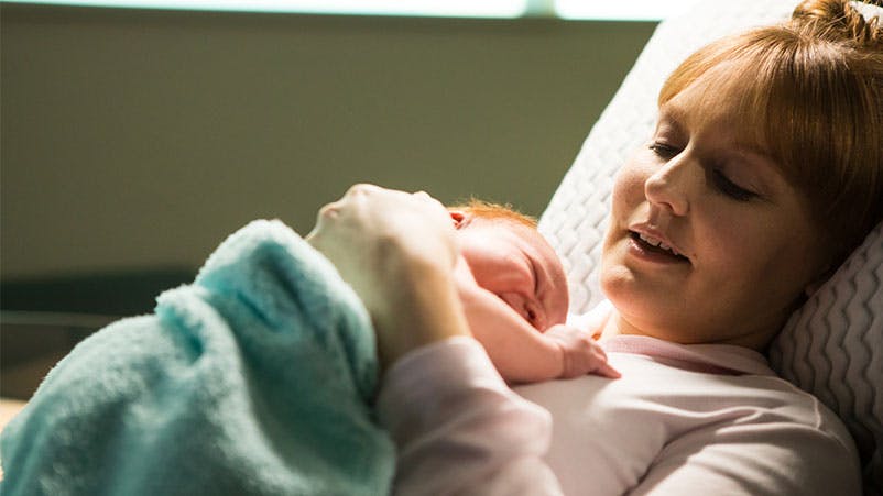 Mom cradles newborn at Family Birth Center