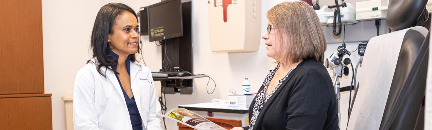 Monica Christmas, MD, with middle aged female patient in clinic