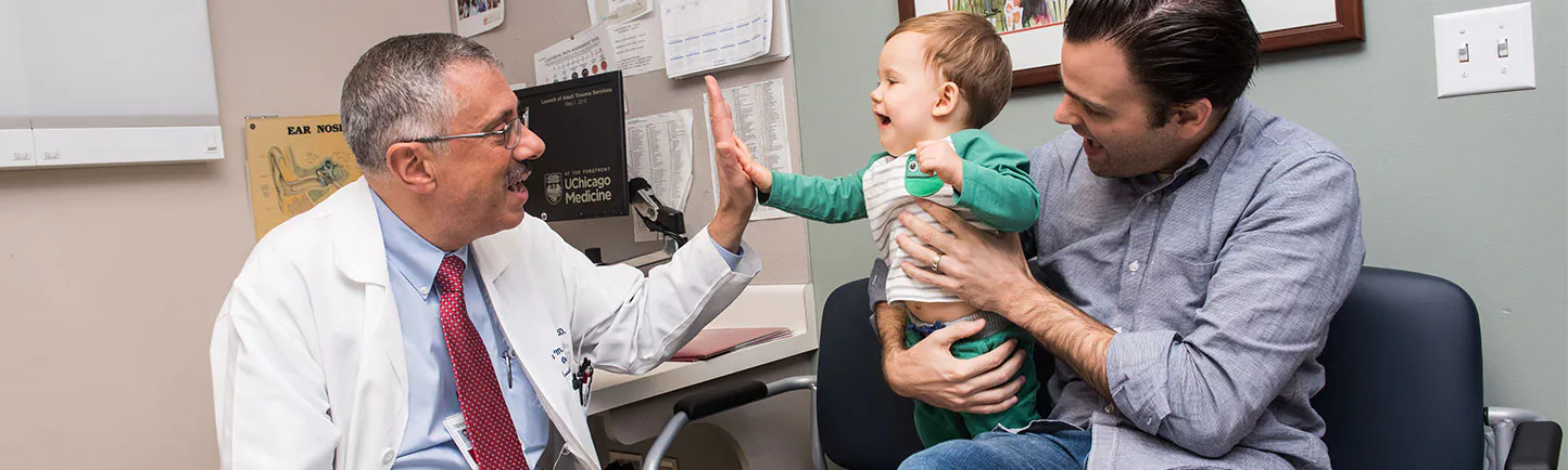 Dr. Baroody giving a high five to a pediatric patient