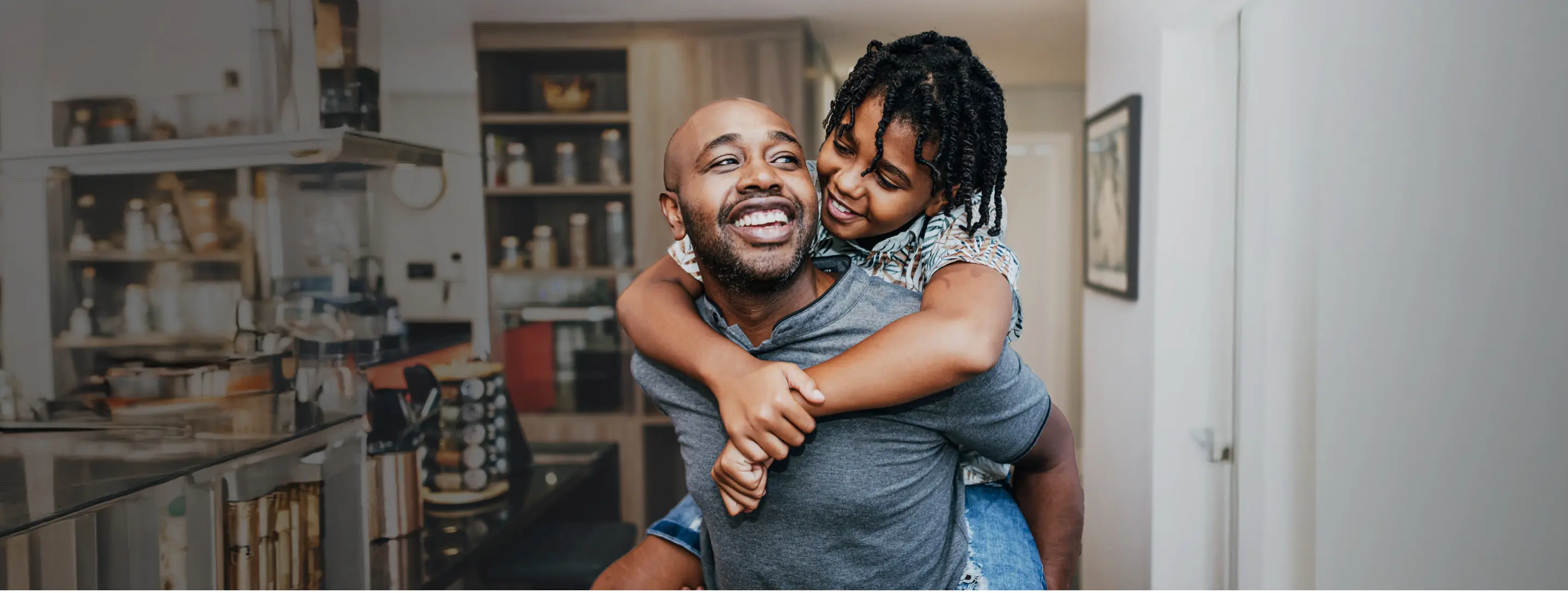 Father with daughter riding on his back, at home