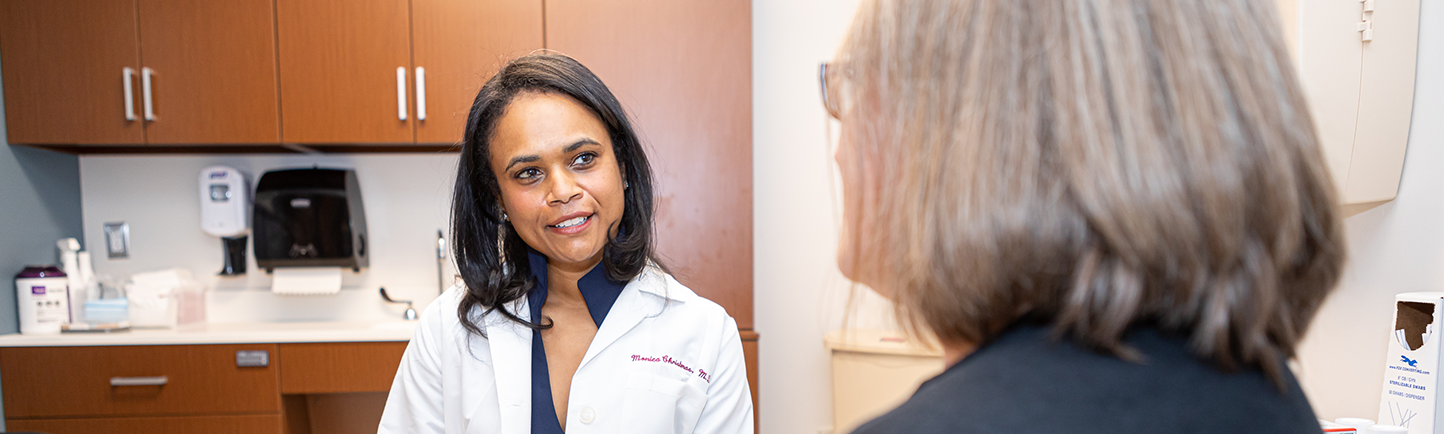Gynecologist Monica Christmas, MD, consults with a patient