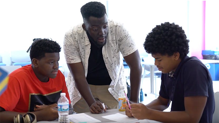 Michael "MJ" Johnson, Community Engagement Specialists, with two students from the Design Thinking Lab