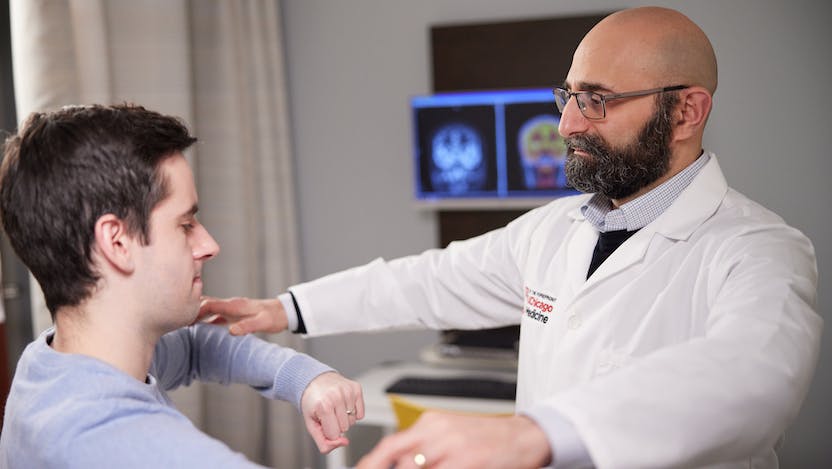Naoum Issa, MD, PhD, consults with an epilepsy patient in the clinic.