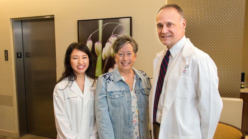Patient Elaine Johnson (center) with Grace Suh and Michael Bishop 
