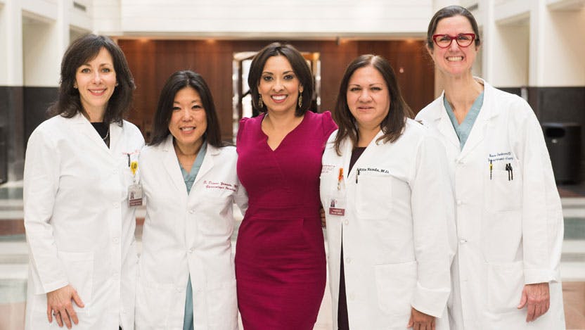 Breast cancer survivor Michelle Kerulis is flanked by her physicians, Stacy Lindau, Diane Yamada, Rita Nanda, Nora Jaskowiak